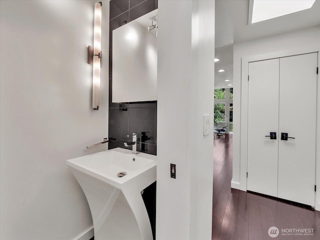 13893 NE 69th St Unit 689, Redmond, WA 98052 - bathroom with wood finished floors and tasteful backsplash