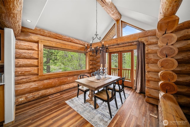3105 Tamarack Pl, Wenatchee, WA 98801 - dining area featuring log walls, a chandelier, beamed ceiling, hardwood / wood-style floors, and high vaulted ceiling