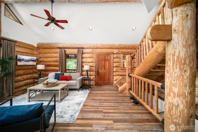 3105 Tamarack Pl, Wenatchee, WA 98801 - living area featuring log walls, high vaulted ceiling, a ceiling fan, wood finished floors, and stairs