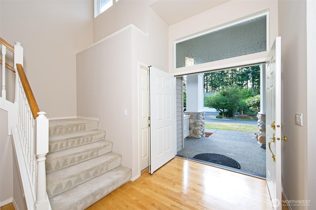 7321 Ashridge Ave SW, Port Orchard, WA 98367 - entrance foyer featuring stairs, a towering ceiling, and wood finished floors
