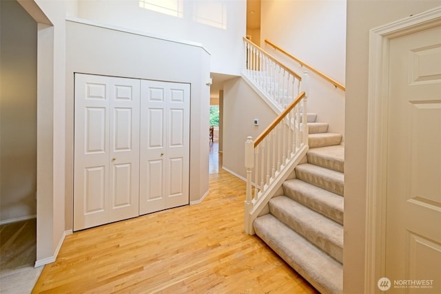 7321 Ashridge Ave SW, Port Orchard, WA 98367 - foyer entrance with light wood-type flooring, stairway, and a towering ceiling