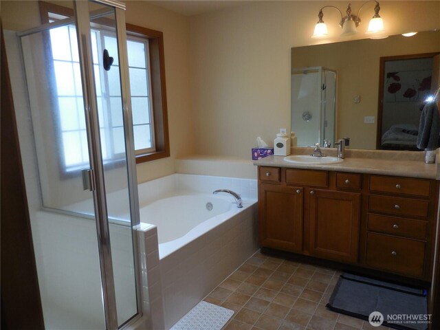 4558 SE Bakken Ct, Port Orchard, WA 98366 - ensuite bathroom with vanity, a shower stall, a garden tub, and tile patterned floors