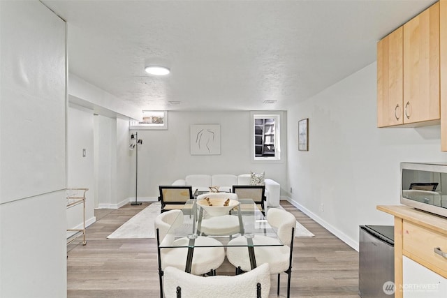9520 2nd Ave NW, Seattle, WA 98117 - dining room with light wood finished floors and baseboards