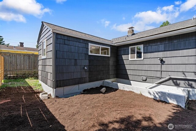 9520 2nd Ave NW, Seattle, WA 98117 - view of side of property with a chimney and roof with shingles
