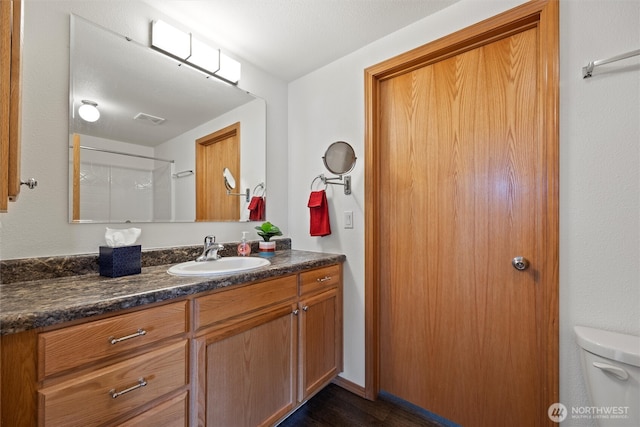 324 Mojave Ct, West Richland, WA 99353 - bathroom featuring vanity, toilet, and wood finished floors
