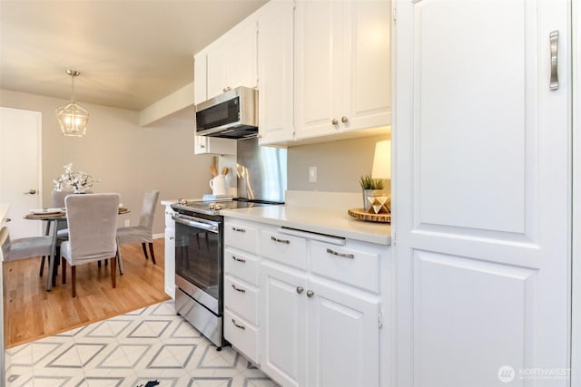 30240 7th Ave S, Federal Way, WA 98003 - kitchen with stainless steel appliances, light countertops, white cabinets, pendant lighting, and light floors
