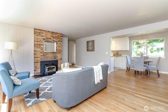 30240 7th Ave S, Federal Way, WA 98003 - living area featuring light wood-type flooring, a wood stove, and baseboards