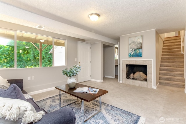 30240 7th Ave S, Federal Way, WA 98003 - carpeted living room with a textured ceiling, stairs, a tile fireplace, and baseboards