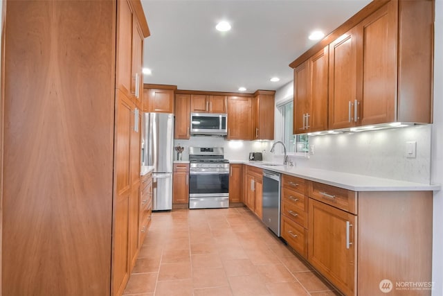 35432 18th Ave SW, Federal Way, WA 98023 - kitchen with appliances with stainless steel finishes, a sink, brown cabinetry, light countertops, and recessed lighting