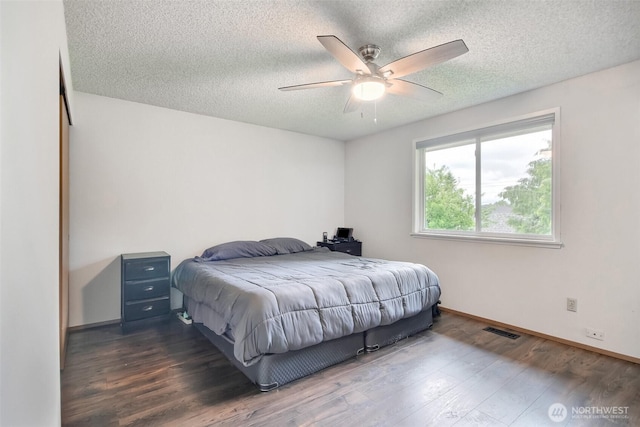35432 18th Ave SW, Federal Way, WA 98023 - bedroom featuring dark wood finished floors, a textured ceiling, baseboards, and ceiling fan
