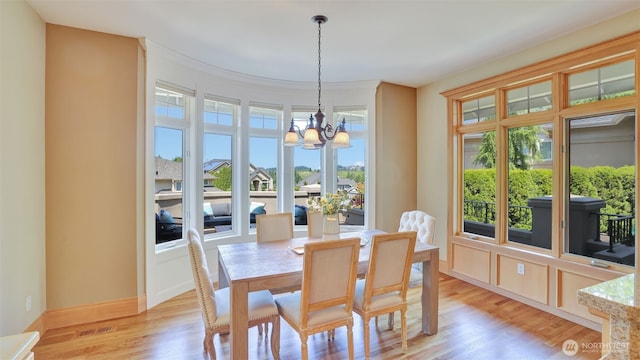 8504 146th Pl SE, Newcastle, WA 98059 - dining area featuring a chandelier, light wood-type flooring, and baseboards