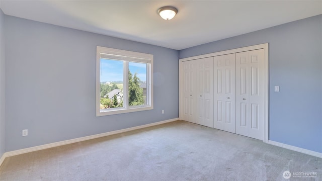 8504 146th Pl SE, Newcastle, WA 98059 - unfurnished bedroom featuring carpet flooring, baseboards, and a closet