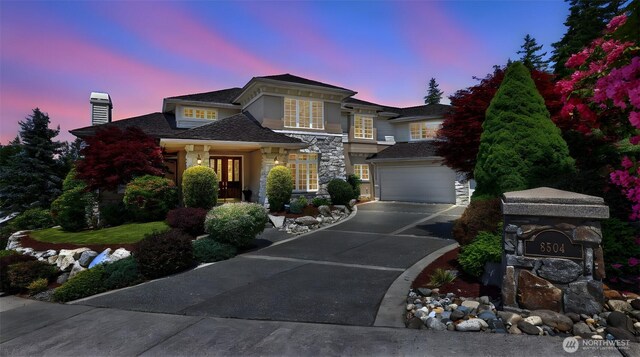8504 146th Pl SE, Newcastle, WA 98059 - view of front of home with driveway, a chimney, an attached garage, stone siding, and french doors