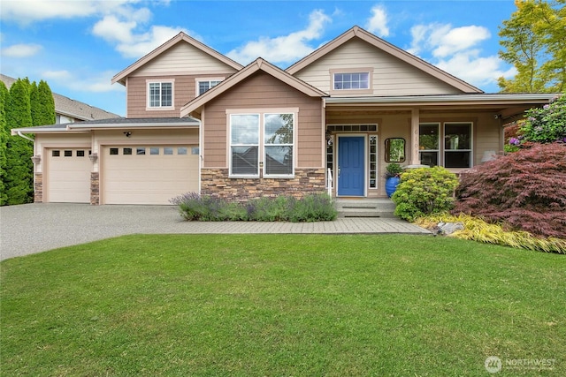 6103 153rd Ave E, Sumner, WA 98390 - view of front of house with driveway, a front lawn, stone siding, and an attached garage