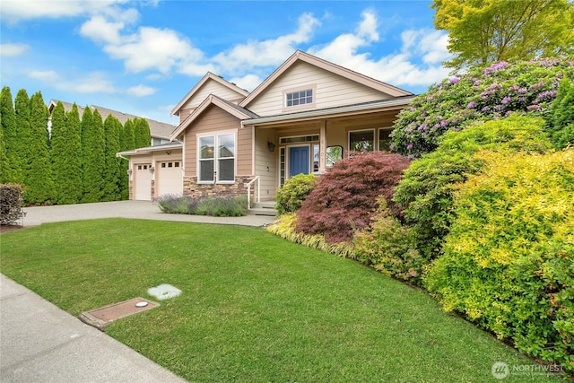 6103 153rd Ave E, Sumner, WA 98390 - craftsman-style home featuring a front yard, driveway, an attached garage, stone siding, and covered porch