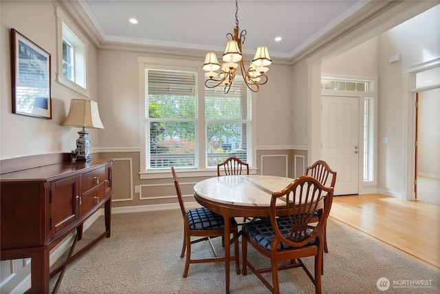 6103 153rd Ave E, Sumner, WA 98390 - dining room featuring healthy amount of natural light, crown molding, a chandelier, wainscoting, and a decorative wall