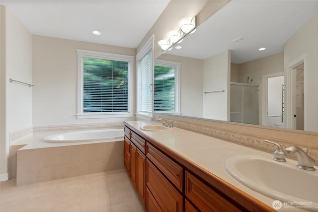 6103 153rd Ave E, Sumner, WA 98390 - bathroom with a shower stall, a bath, double vanity, tile patterned floors, and recessed lighting