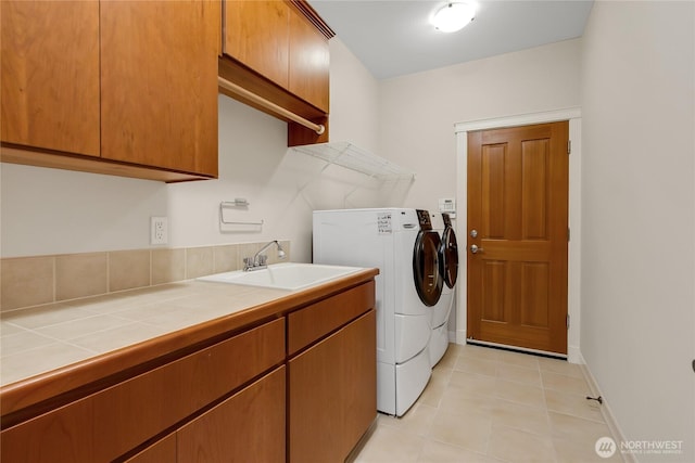 6103 153rd Ave E, Sumner, WA 98390 - washroom featuring independent washer and dryer, cabinet space, and light tile patterned floors