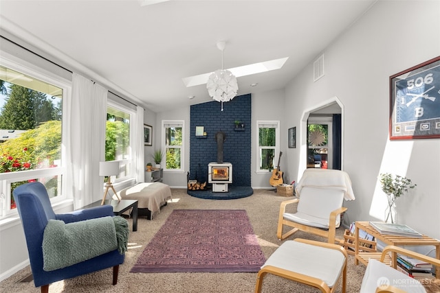 4434 Juli Ct SE, Olympia, WA 98501 - carpeted living room with a skylight, a wood stove, and vaulted ceiling