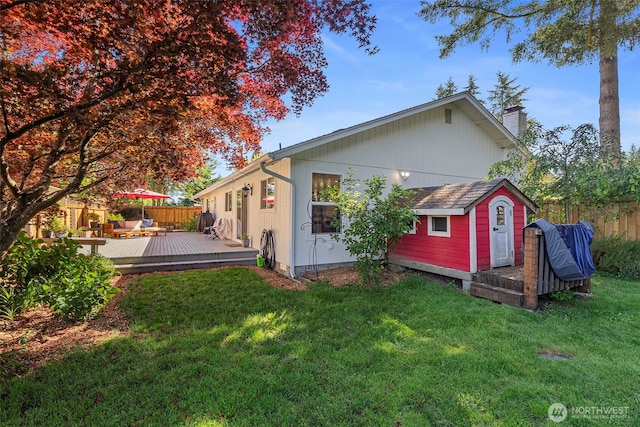 4434 Juli Ct SE, Olympia, WA 98501 - back of house featuring a wooden deck, an outdoor structure, and a chimney