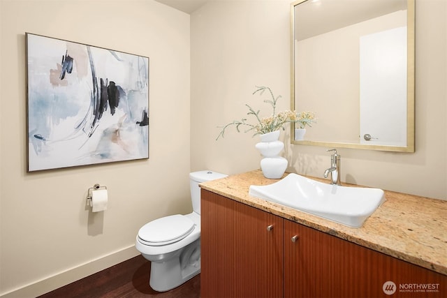 909 5th Ave Unit 303, Seattle, WA 98164 - bathroom with vanity, toilet, baseboards, and wood finished floors