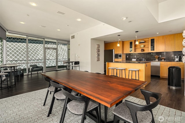 909 5th Ave Unit 303, Seattle, WA 98164 - dining space with wood finished floors, recessed lighting, and expansive windows