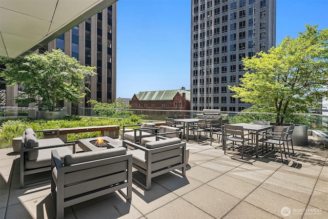 909 5th Ave Unit 303, Seattle, WA 98164 - view of patio / terrace featuring outdoor dining area and an outdoor living space with a fire pit