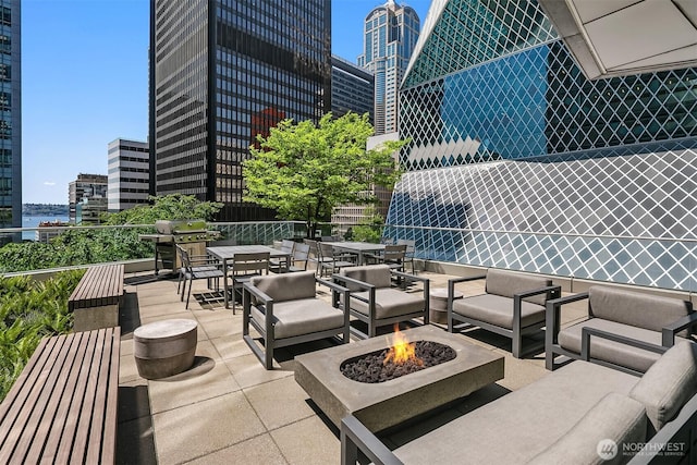 909 5th Ave Unit 303, Seattle, WA 98164 - view of patio with an outdoor living space with a fire pit, a view of city, outdoor dining area, and a grill