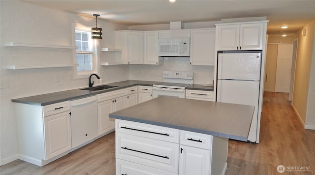137 S Razor Clam Dr SW, Ocean Shores, WA 98569 - kitchen featuring white appliances, open shelves, dark countertops, a sink, and light wood-style floors