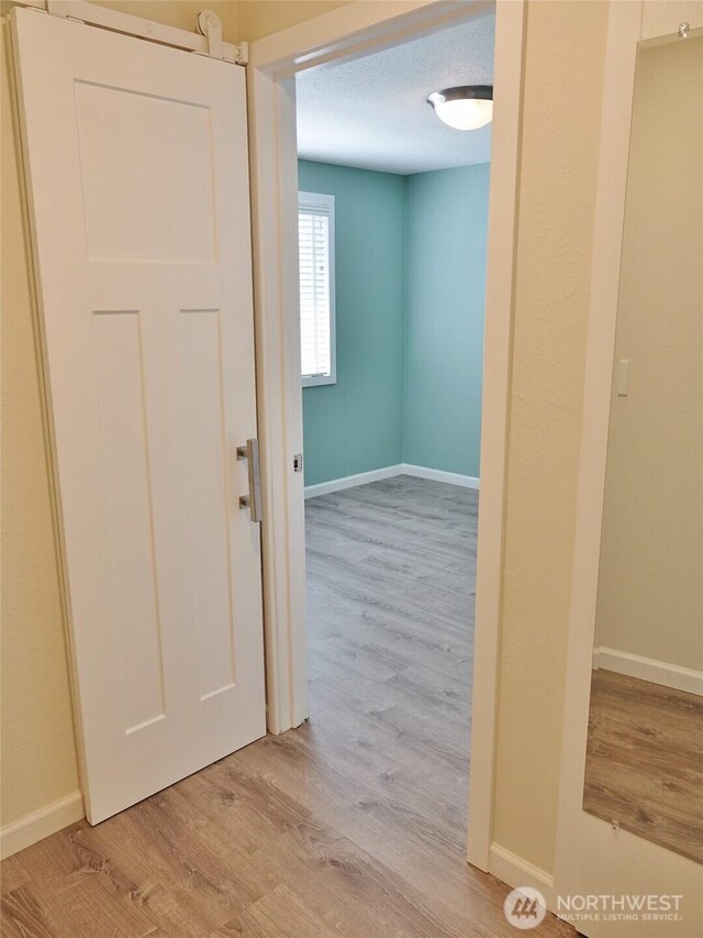 137 S Razor Clam Dr SW, Ocean Shores, WA 98569 - hall featuring light wood-style flooring and baseboards