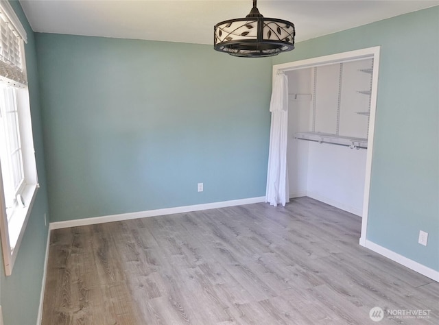 137 S Razor Clam Dr SW, Ocean Shores, WA 98569 - unfurnished dining area with wood finished floors, healthy amount of natural light, and baseboards