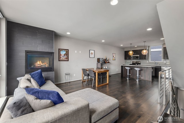 3617 1st Ave NW Unit C, Seattle, WA 98107 - living room with dark wood finished floors, recessed lighting, baseboards, and a tiled fireplace