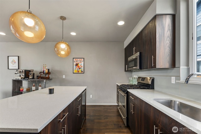 3617 1st Ave NW Unit C, Seattle, WA 98107 - kitchen with appliances with stainless steel finishes, a sink, dark wood finished floors, baseboards, and dark brown cabinets