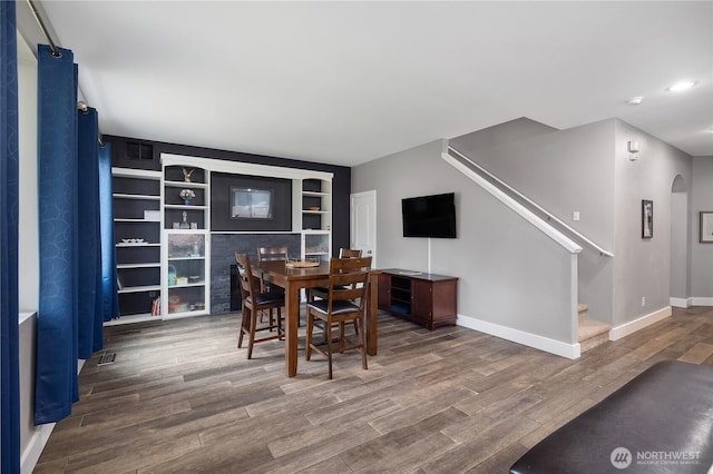 6858 Flute St SE, Lacey, WA 98513 - dining room featuring stairway, wood finished floors, baseboards, recessed lighting, and arched walkways