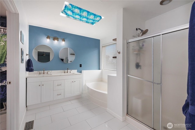 6858 Flute St SE, Lacey, WA 98513 - full bath featuring a shower stall, a bath, double vanity, a skylight, and tile patterned floors
