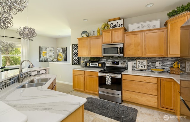 226 Alnus Way, Bremerton, WA 98310 - kitchen with appliances with stainless steel finishes, decorative backsplash, hanging light fixtures, recessed lighting, and light stone counters