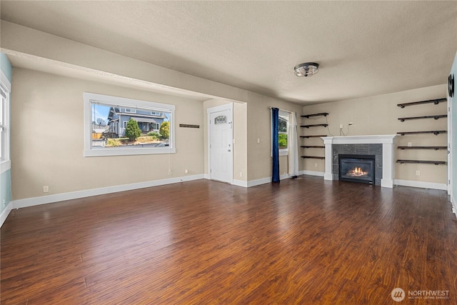 4050 E G St, Tacoma, WA 98404 - unfurnished living room with a textured ceiling, wood finished floors, and a fireplace