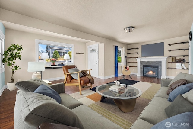 4050 E G St, Tacoma, WA 98404 - living area with wood finished floors, a tiled fireplace, and a textured ceiling