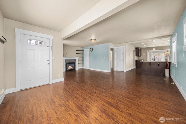 4050 E G St, Tacoma, WA 98404 - unfurnished living room featuring dark wood-type flooring and a fireplace