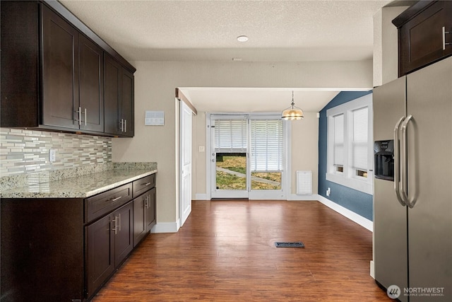 4050 E G St, Tacoma, WA 98404 - kitchen with stainless steel fridge with ice dispenser, dark wood-style floors, backsplash, dark brown cabinets, and lofted ceiling