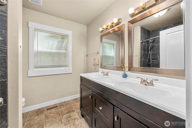 4050 E G St, Tacoma, WA 98404 - full bathroom with double vanity, tiled shower, and stone finish floors