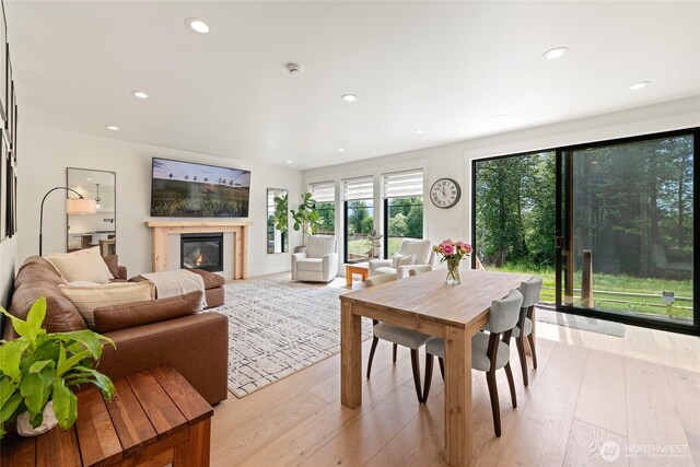 2140 Lagerwey Cir, Lynden, WA 98264 - dining room featuring light wood-style floors, a glass covered fireplace, and recessed lighting