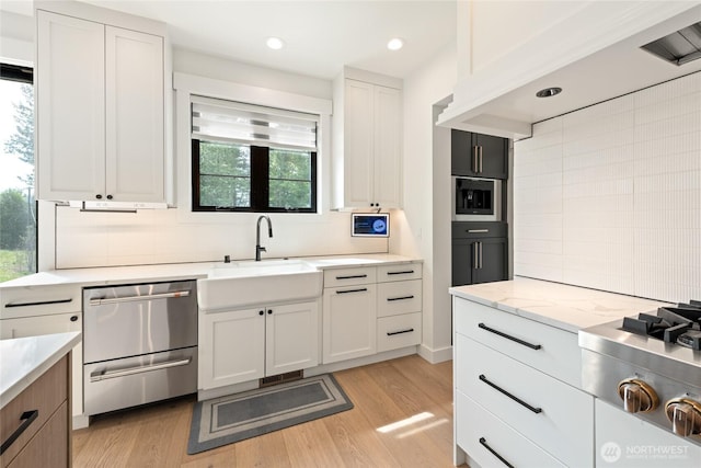 2140 Lagerwey Cir, Lynden, WA 98264 - kitchen featuring stainless steel appliances, tasteful backsplash, light wood finished floors, light stone counters, and recessed lighting