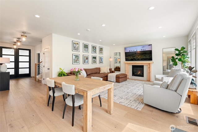 2140 Lagerwey Cir, Lynden, WA 98264 - living room featuring recessed lighting, light wood-style floors, a glass covered fireplace, and stairs