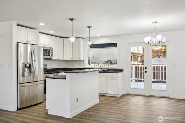 16931 20th Dr SE, Bothell, WA 98012 - kitchen featuring appliances with stainless steel finishes, wood finished floors, white cabinetry, and recessed lighting