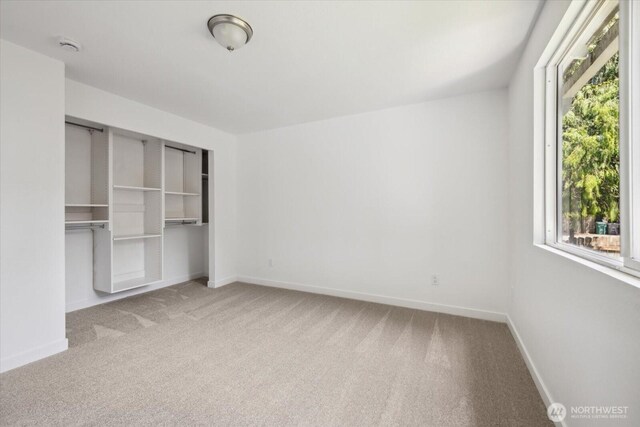 16931 20th Dr SE, Bothell, WA 98012 - unfurnished bedroom with carpet, baseboards, and a closet