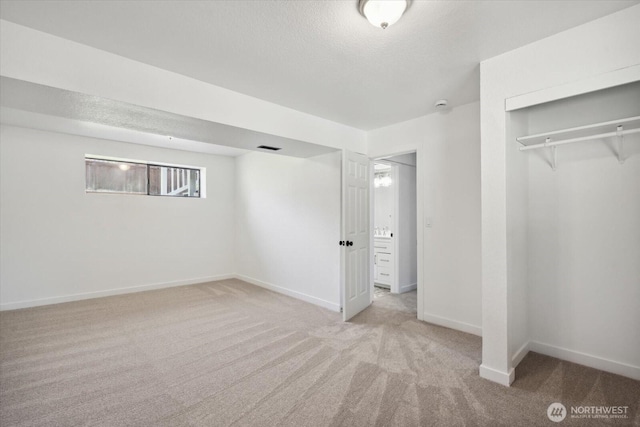 16931 20th Dr SE, Bothell, WA 98012 - unfurnished bedroom with carpet, a closet, a textured ceiling, and baseboards