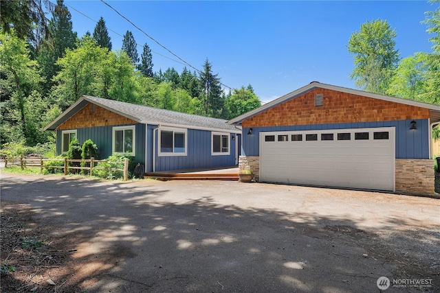 9341 Littlerock Rd SW, Olympia, WA 98512 - view of front of home with stone siding, a detached garage, and an outdoor structure