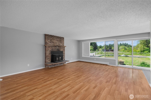 9341 Littlerock Rd SW, Olympia, WA 98512 - unfurnished living room featuring a textured ceiling, light wood-style flooring, and baseboards