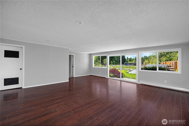 9341 Littlerock Rd SW, Olympia, WA 98512 - unfurnished living room with a baseboard radiator, a textured ceiling, baseboard heating, baseboards, and wood finished floors